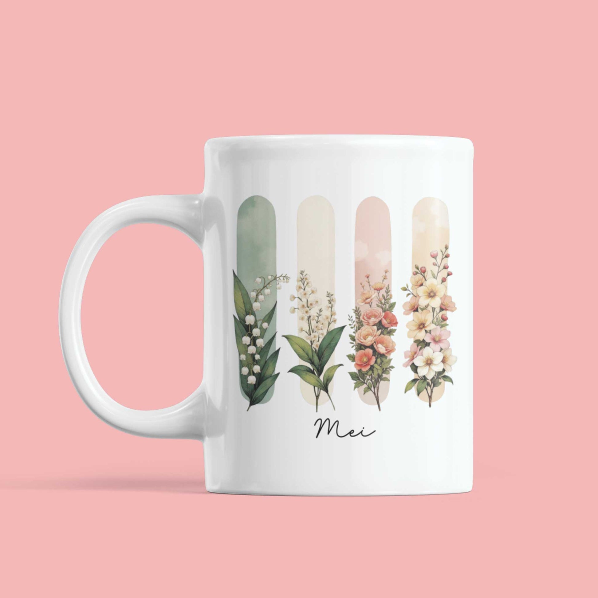 Witte mok tegen roze achtergrond met bloemillustraties in aquarelstijl en ‘Mei’ in elegante handlettering – fris en betekenisvol design.