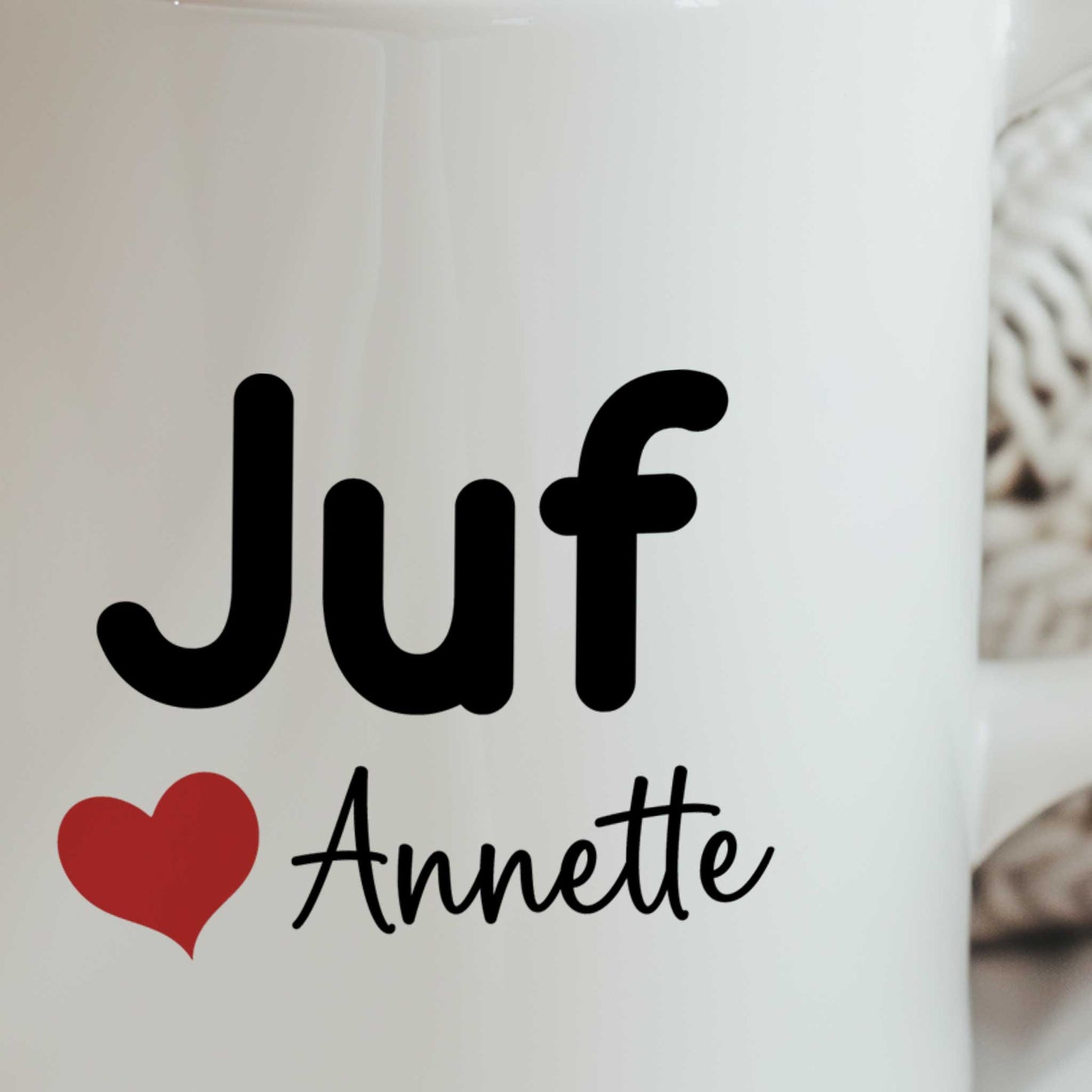 Close-up van een witte mok met de tekst Juf, een rood hartje en de naam Annette