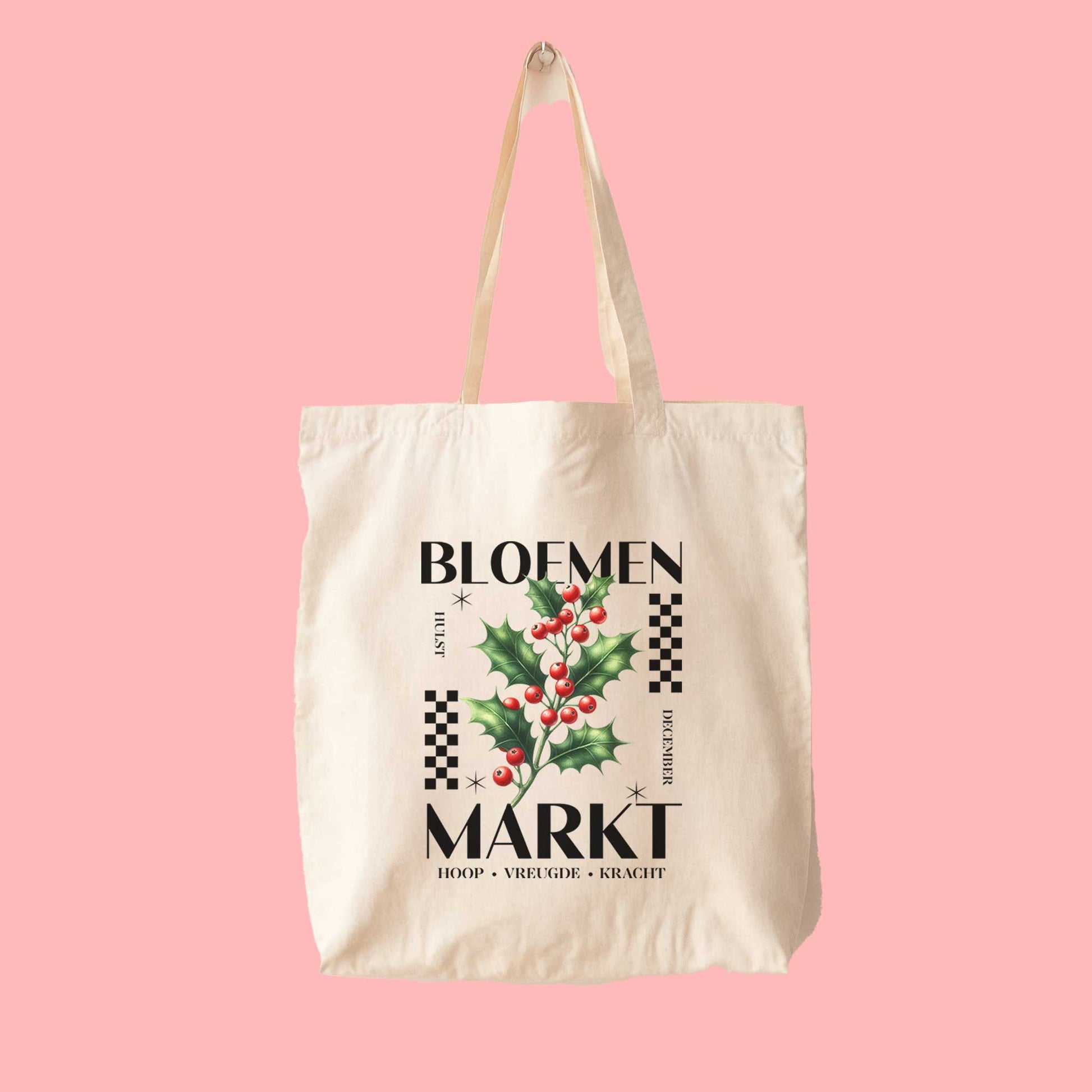 totebag met  de tekst bloemenmarkt en een illustratie van een geboortebloem van de maand december, hulst. Met onderaan de kernwoorden van deze maand : hoop, vreugde, kracht.