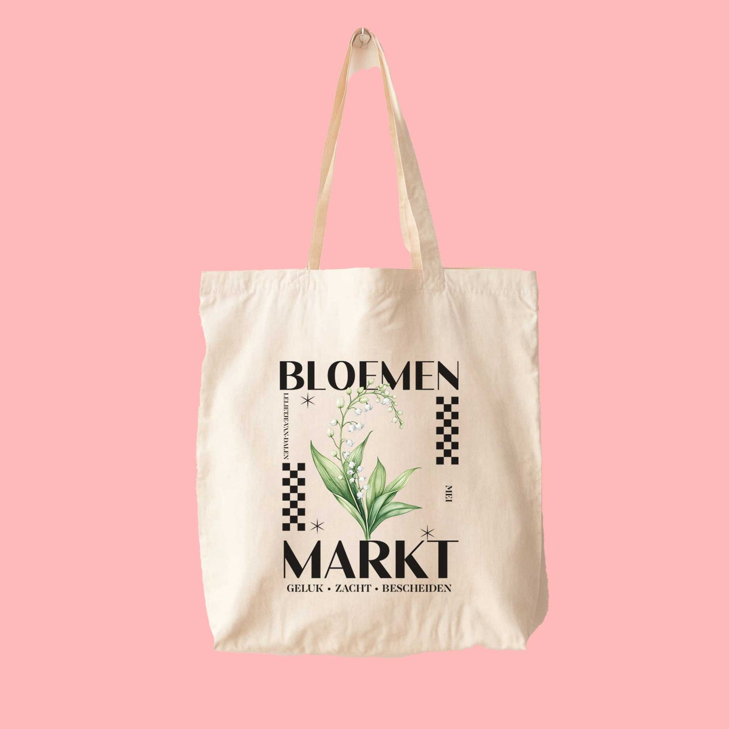 totebag met  de tekst bloemenmarkt en een illustratie van een geboortebloem van de maand mei, een Lelietje-van-dalen. Met onderaan de kernwoorden van deze maand : geluk,zacht,bescheiden.