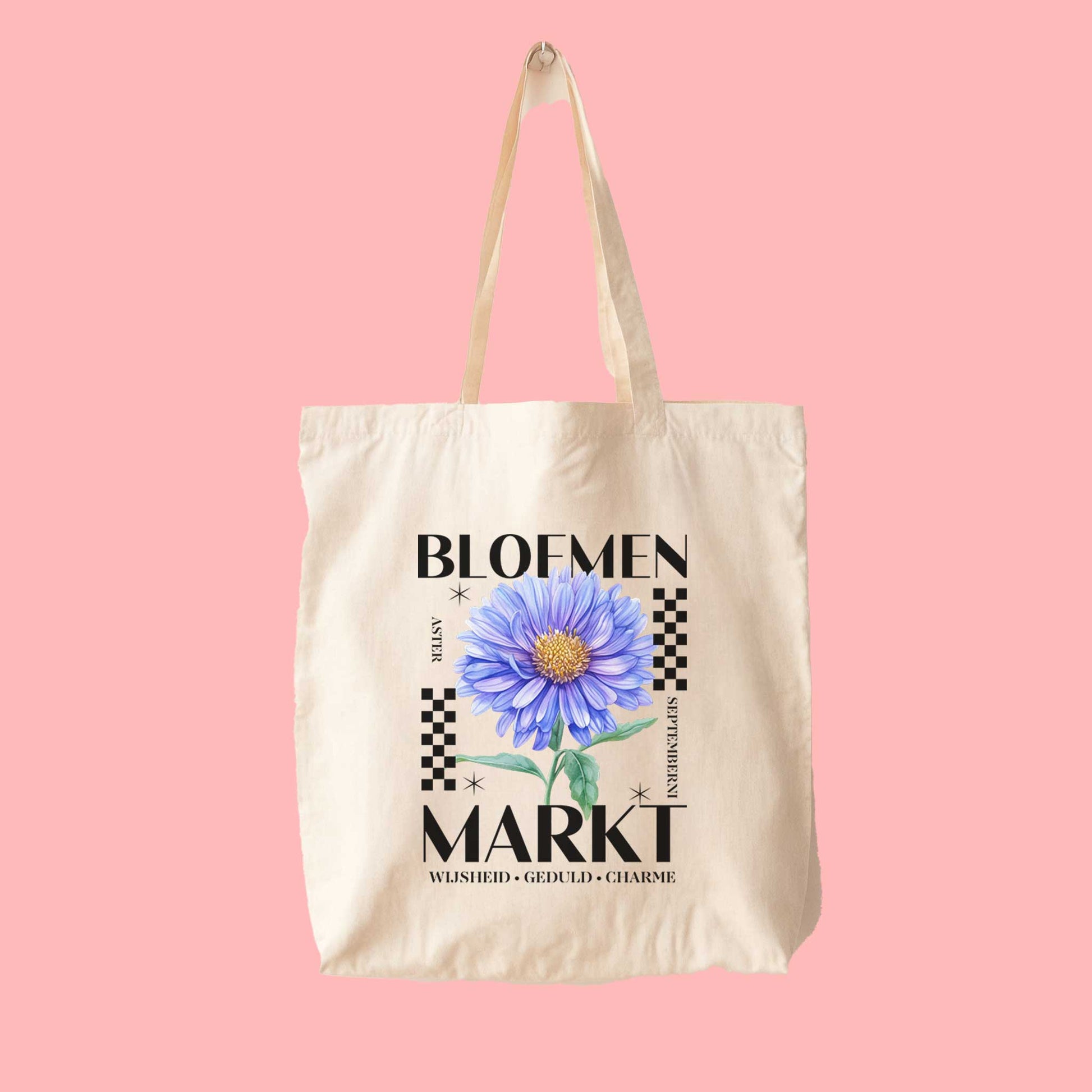 totebag met  de tekst bloemenmarkt en een illustratie van een geboortebloem van de maand september, aster. Met onderaan de kernwoorden van deze maand : wijsheid, geduld, charme.