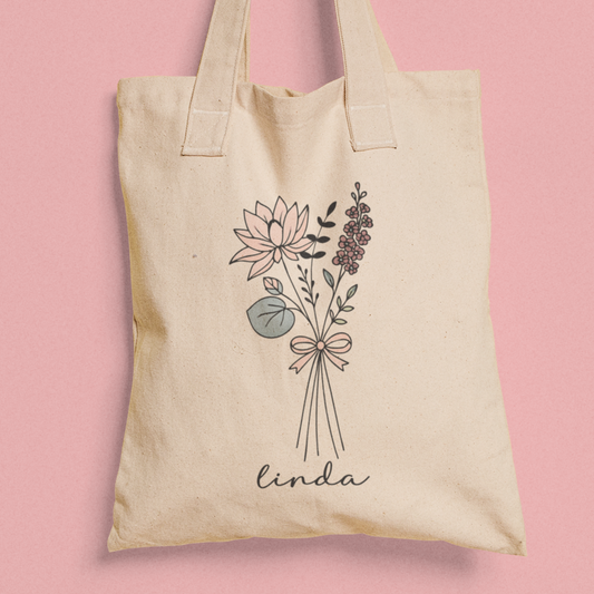 Totebag met bloemen lijnillustratie en naam Linda op roze achtergrond